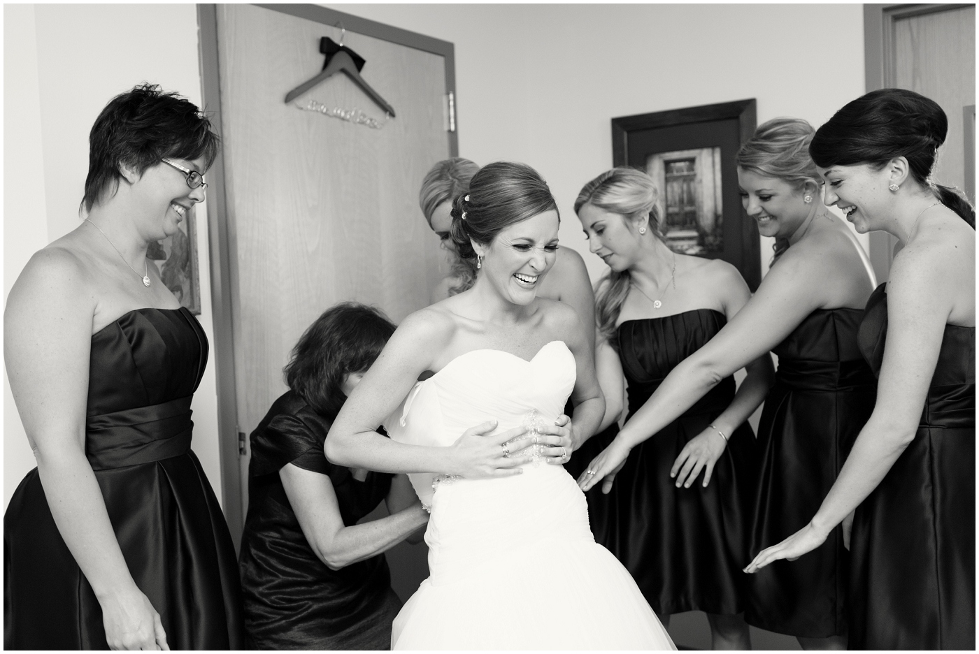 picture of a bride getting in her dress