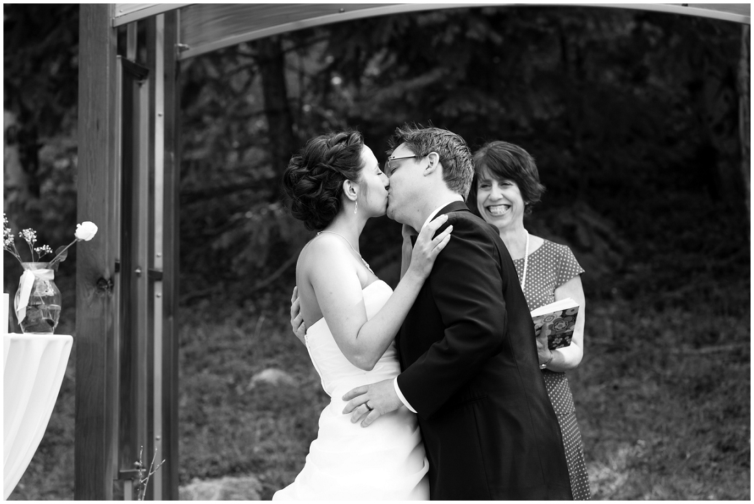 photo of bride and groom first kiss