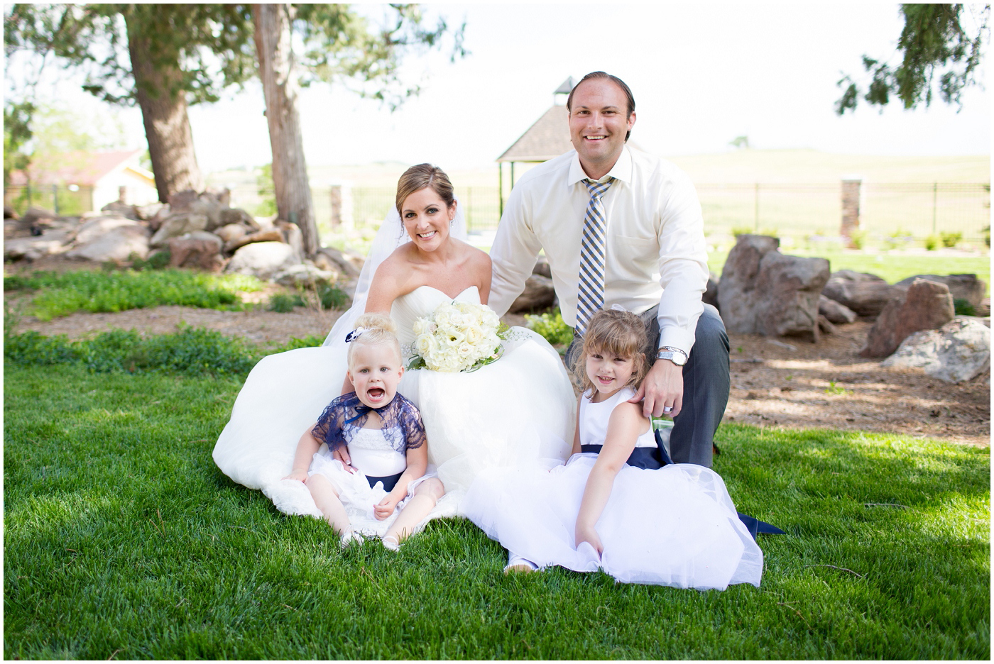 picture of bride & groom with flower girls