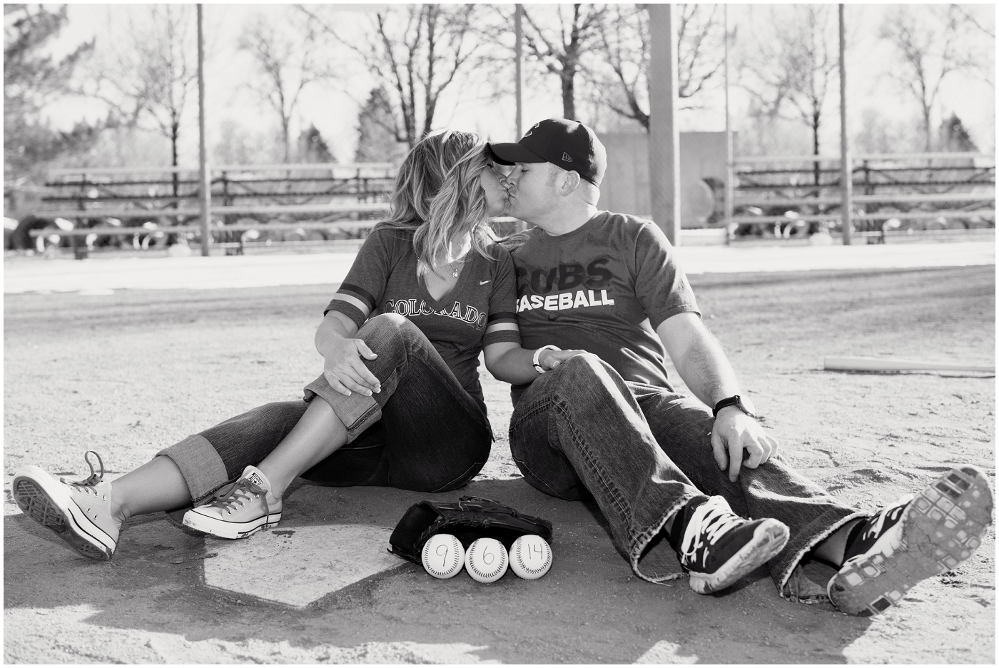 picture of a couple kissing on a baseball field