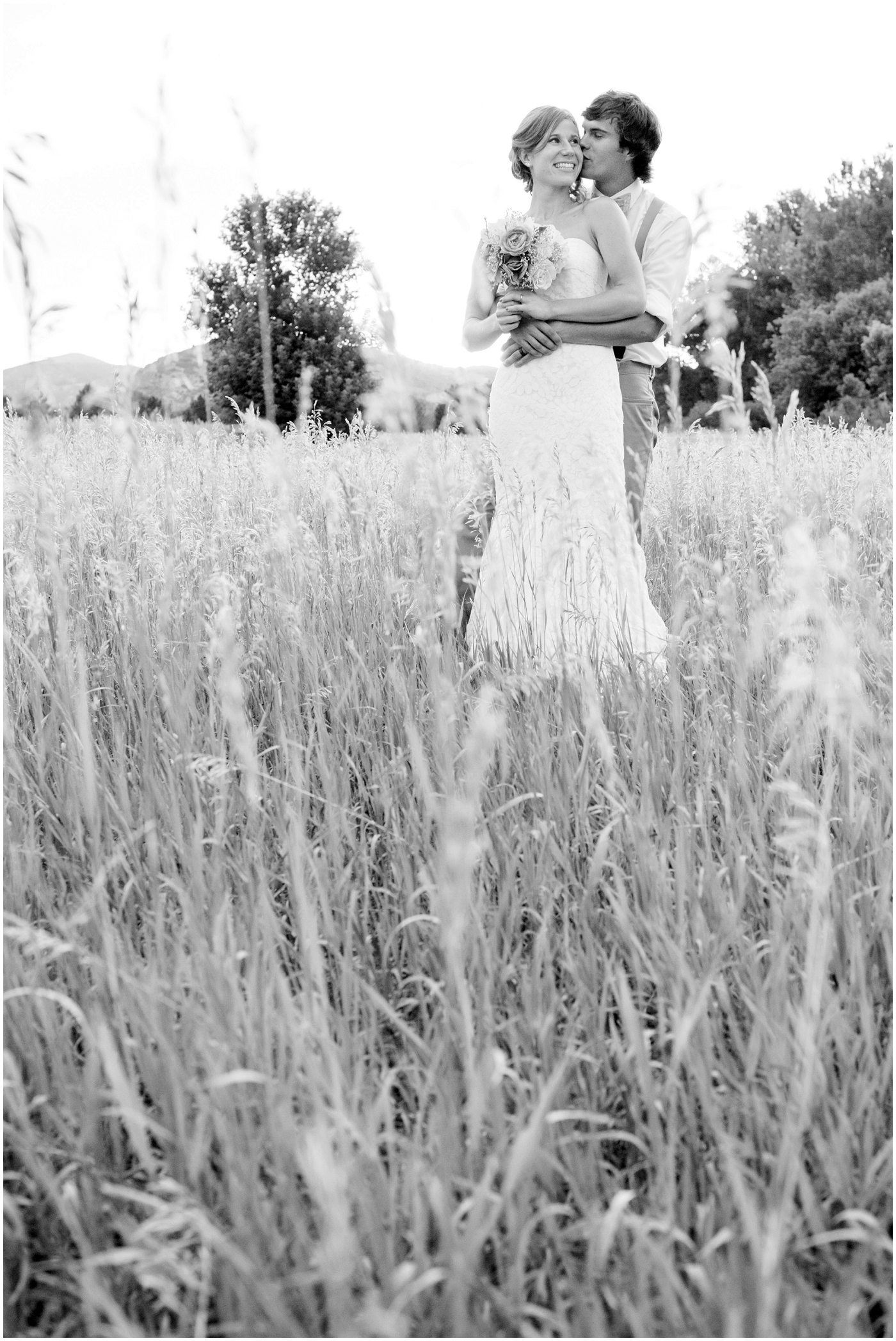 picture of a bride and groom in field