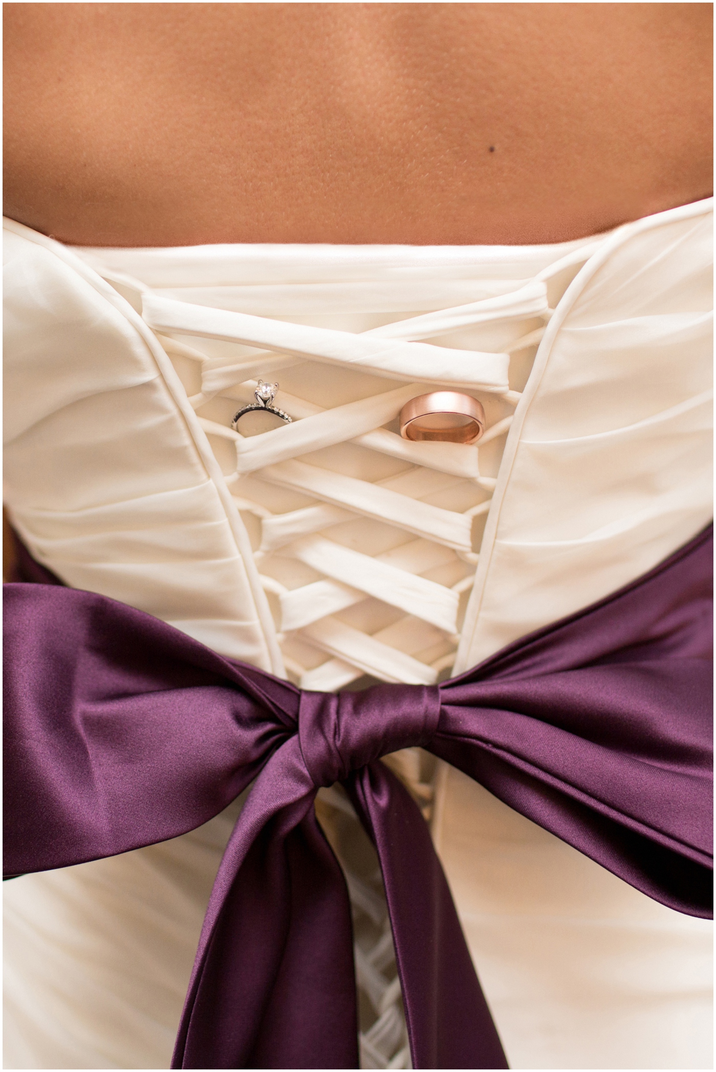 picture of wedding rings on wedding dress