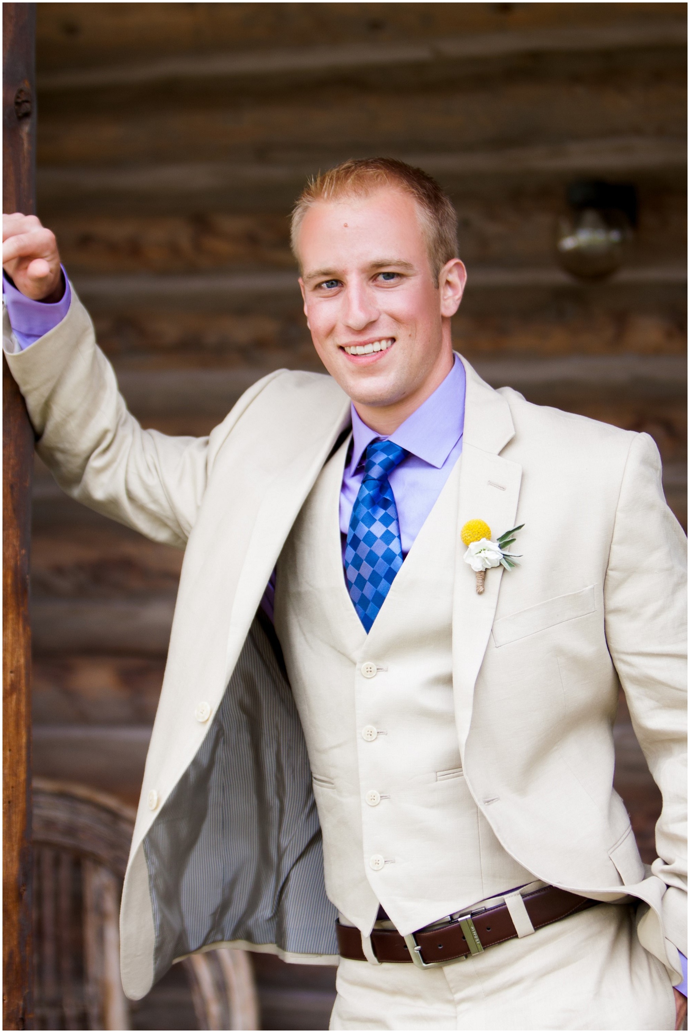 picture of groom at rustic cabin