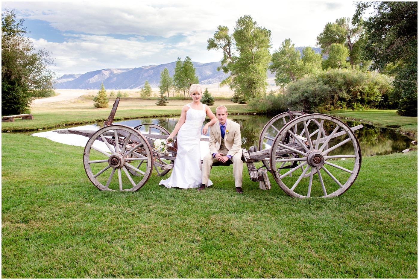 picture of bride and groom with rustic wagon wheel