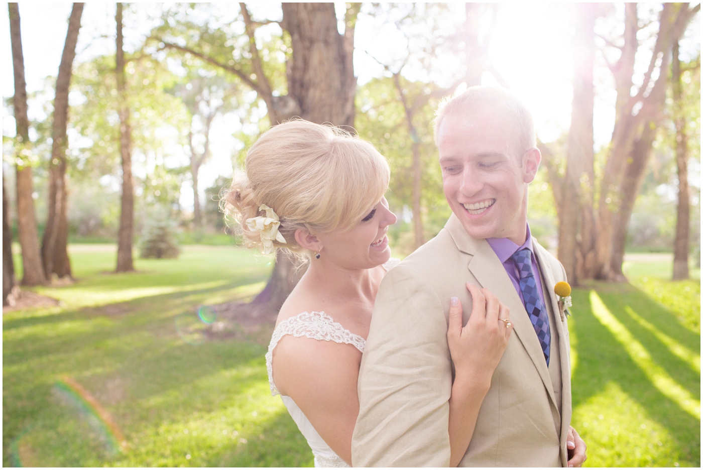 picture of bride and groom with sunflare