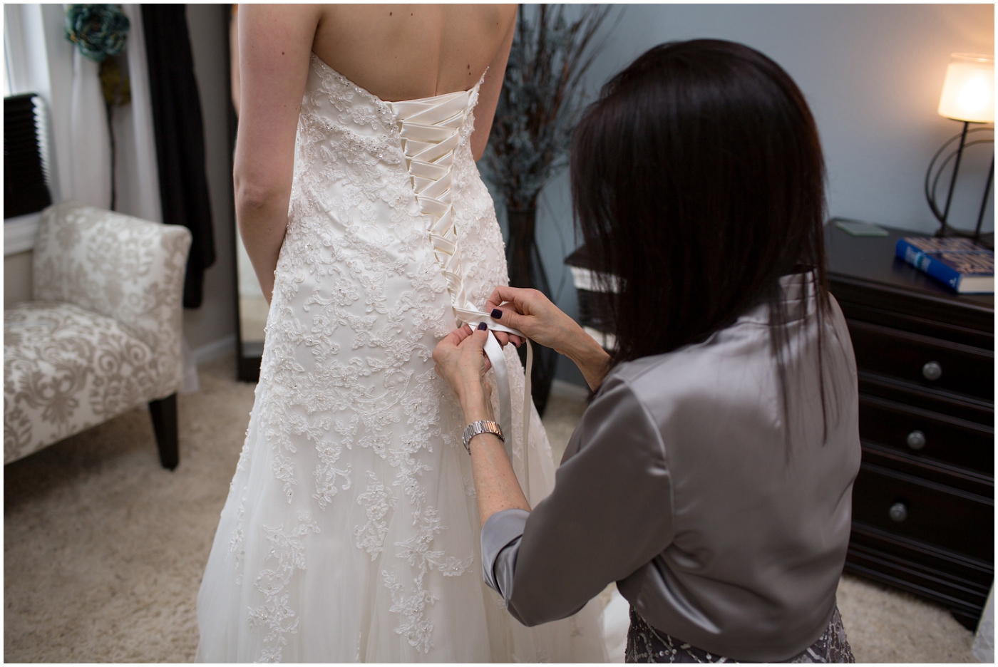 picture of bride getting in her wedding dress