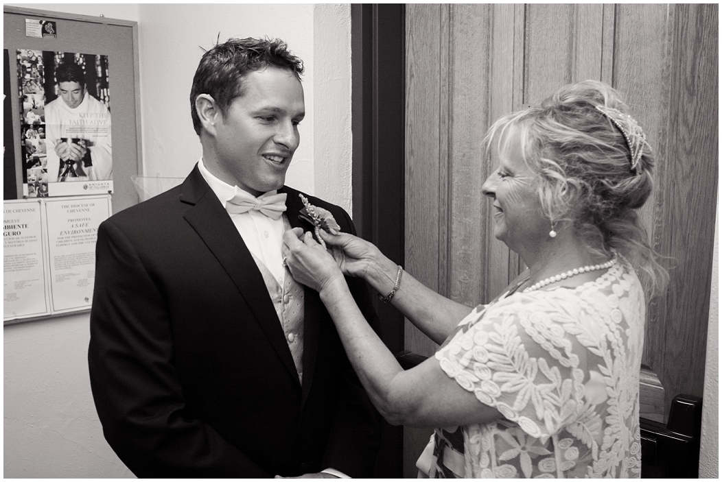 picture of groom getting a boutonniere put on