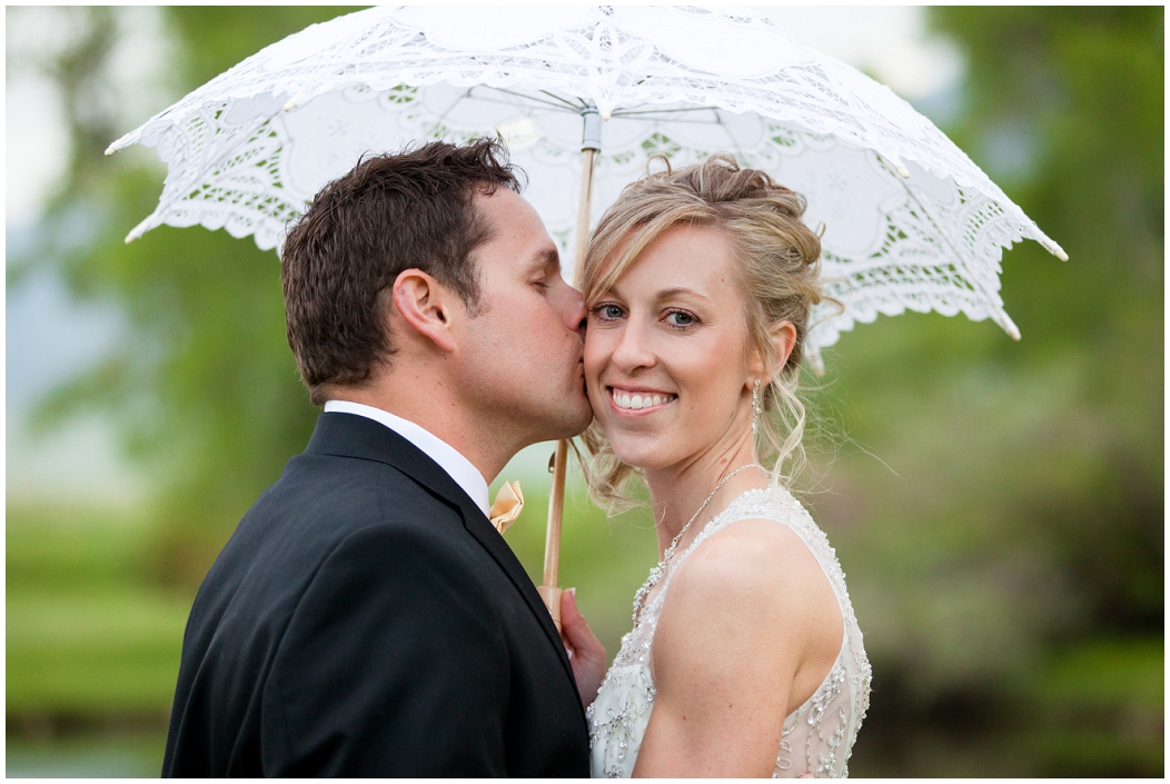 picture of bride and groom with a parasol