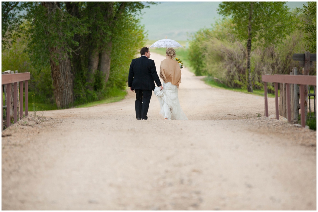 picture of bride and groom walking on a dirt road