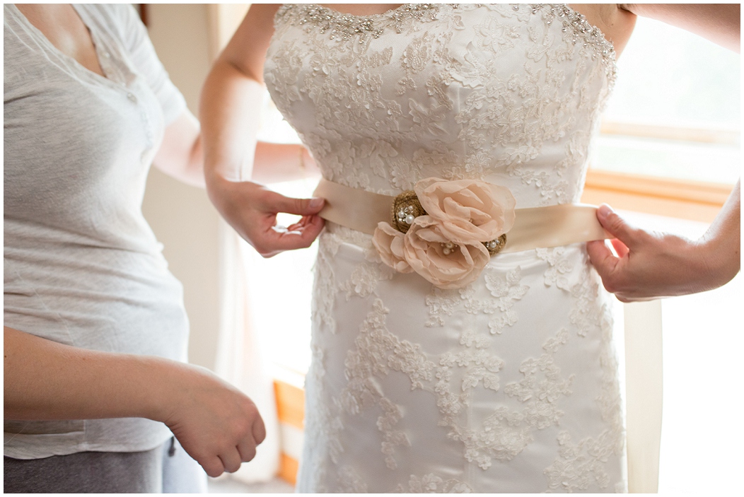 picture of bride putting on her dress