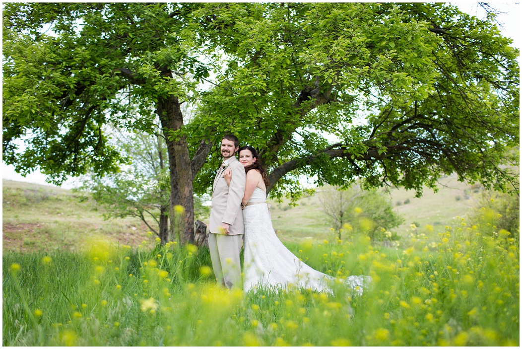 picture of bride and groom with wildflowers