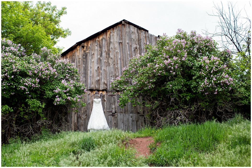 picture of wedding dress hanging on a barn
