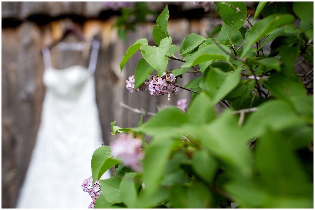 picture of wedding dress hanging on a barn