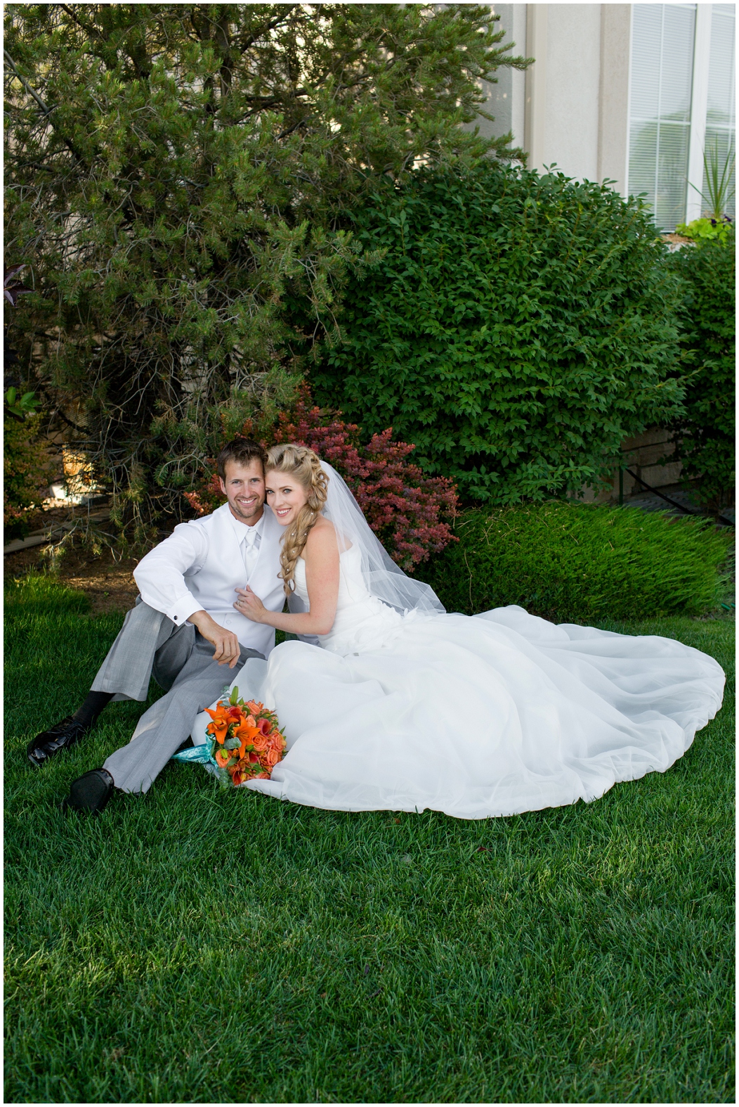 picture of bride and groom sitting in a garden