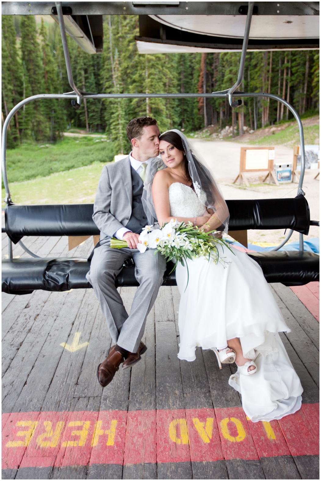 picture of bride and groom on a chairlift