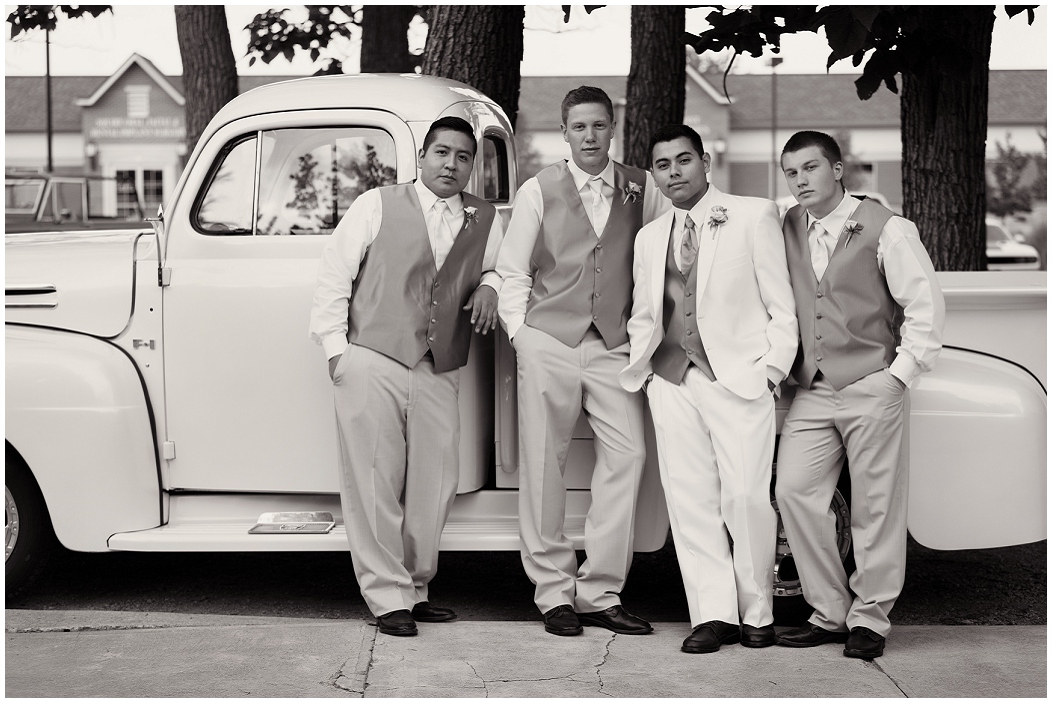 picture of groomsmen by a truck