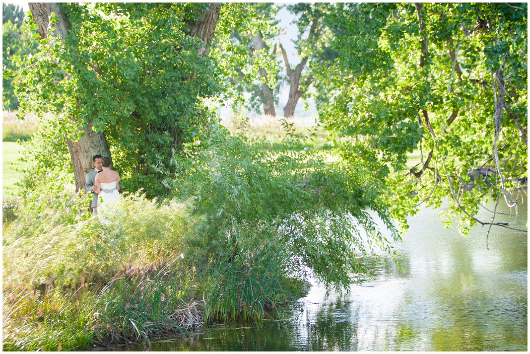 picture of bride and groom by a lake 