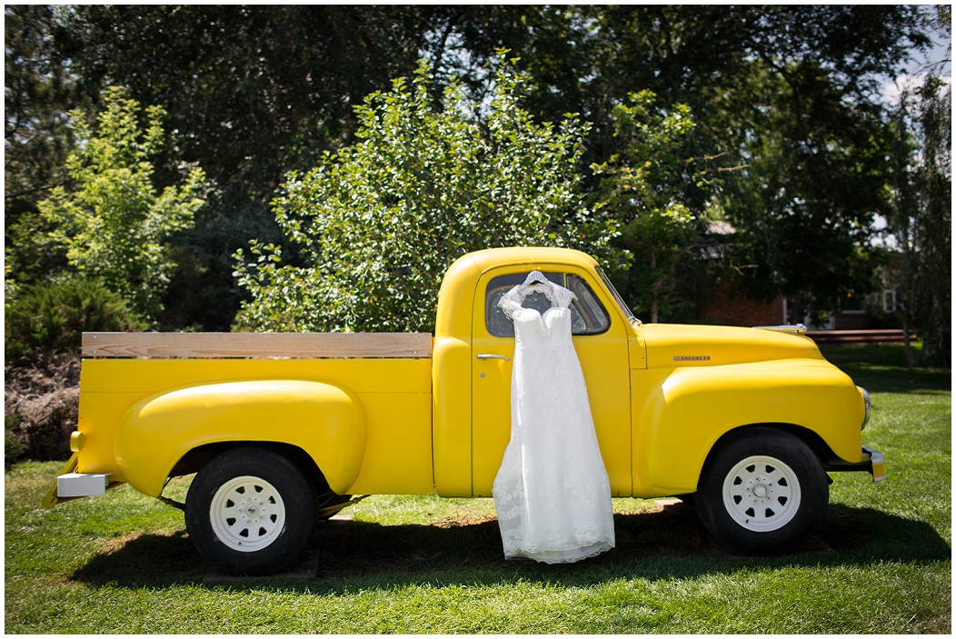 picture of brides dress hanging on an old truck