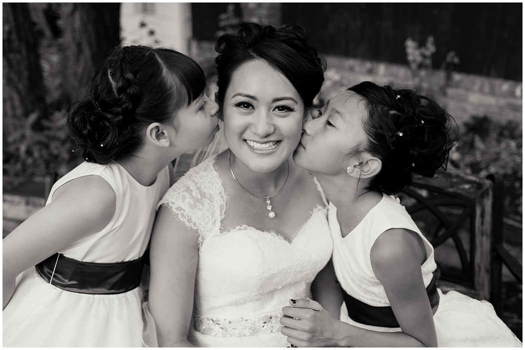 picture of flower girls kissing bride