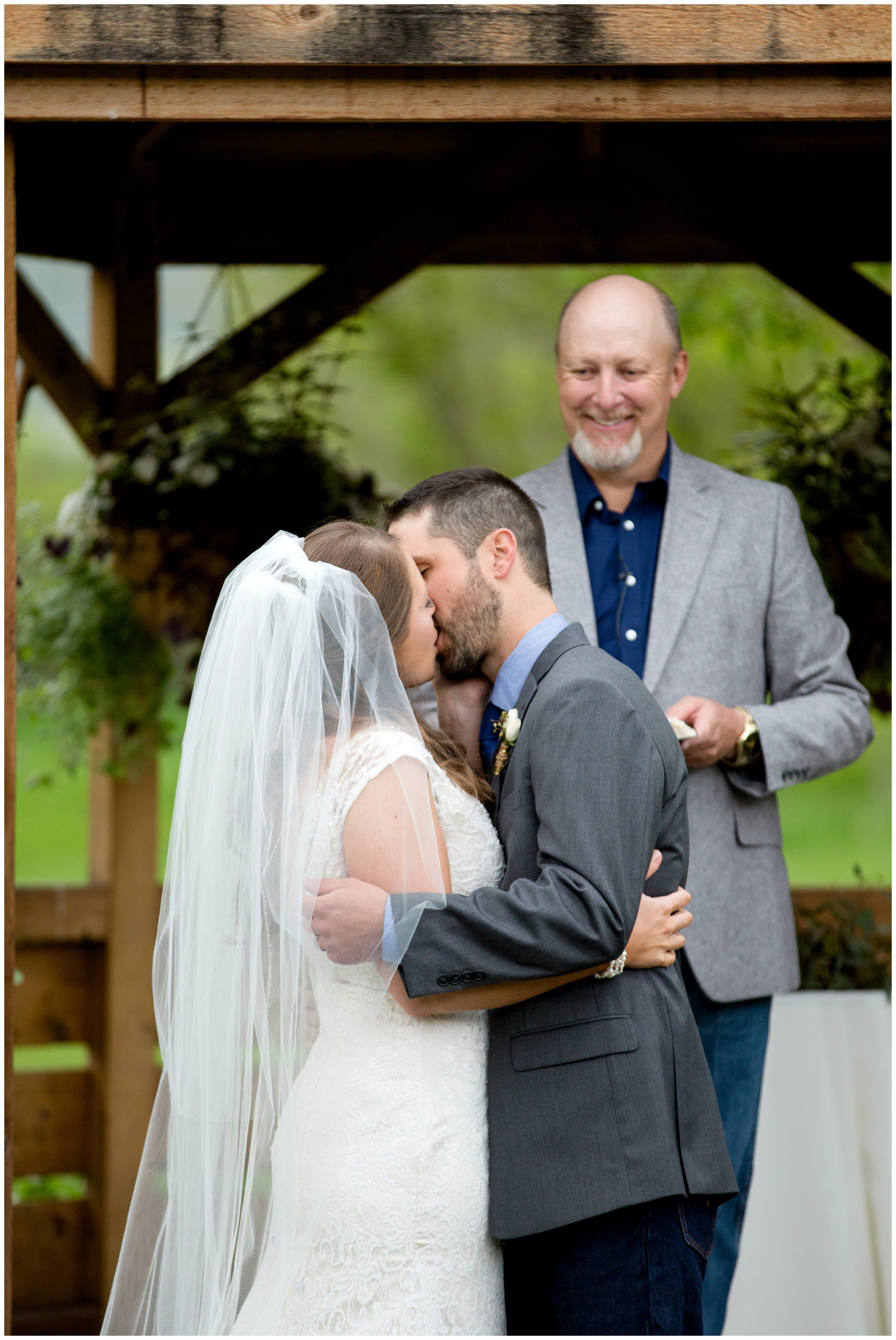 bride and groom's first kiss at Colorado wedding