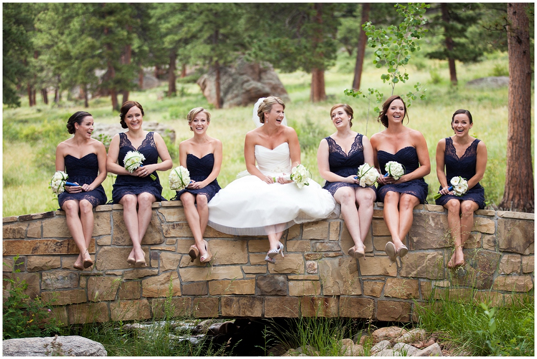picture of bride and bridesmaids on a bridge