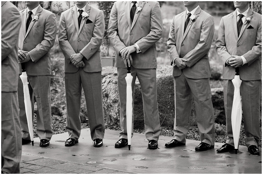 picture of groomsmen holding umbrellas