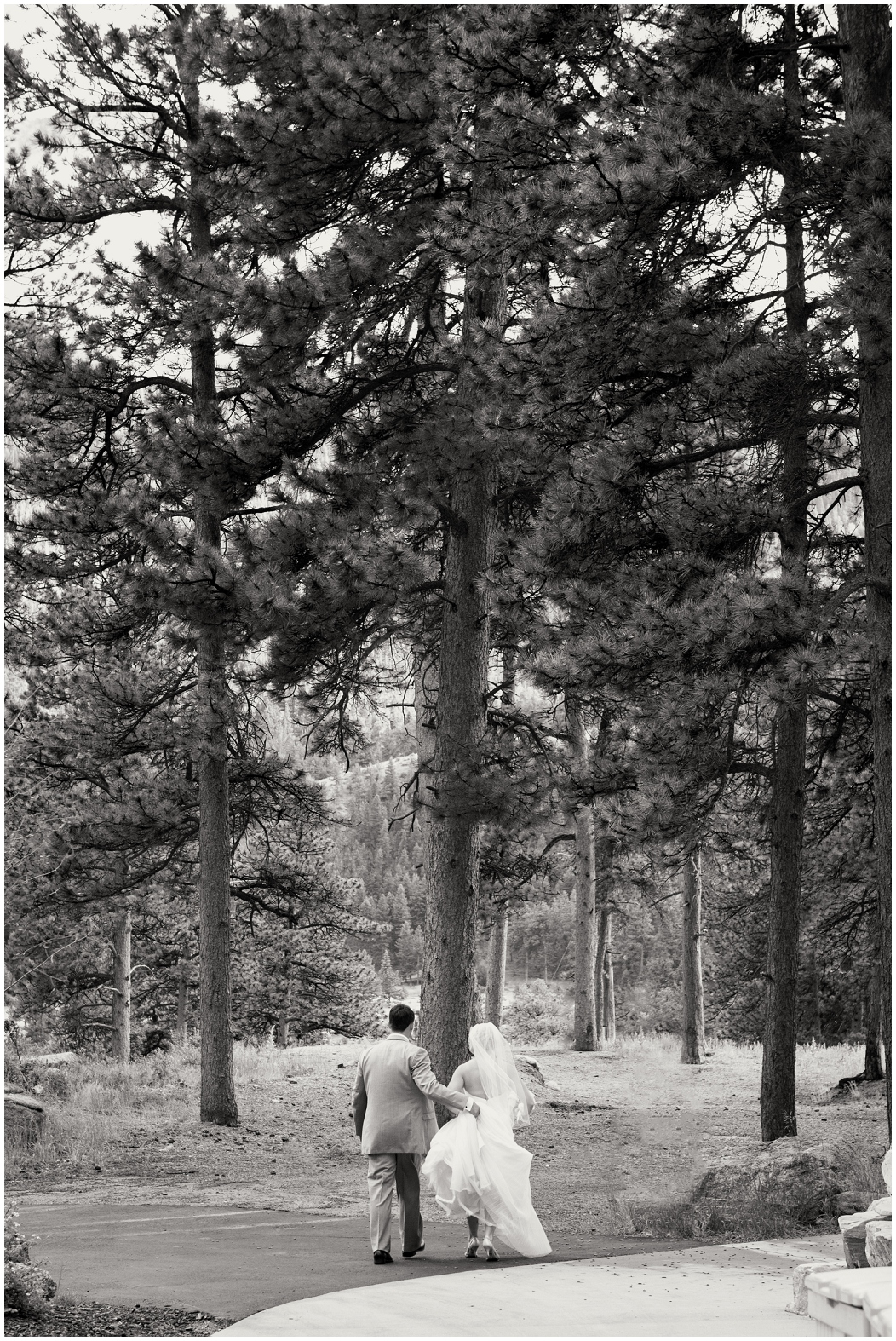 picture of bride and groom walking in the forest