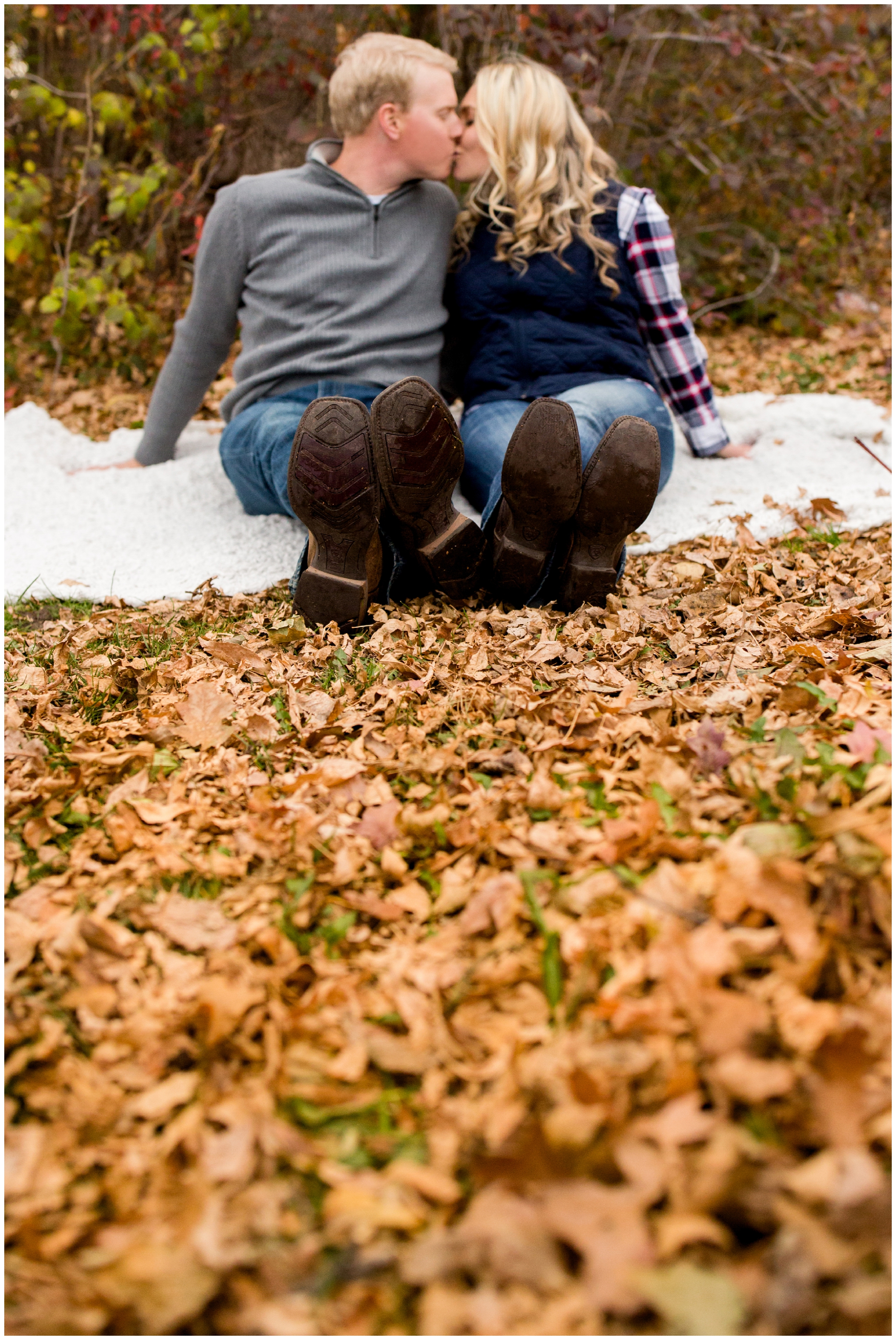fall Colorado engagement photos sitting in leaves 