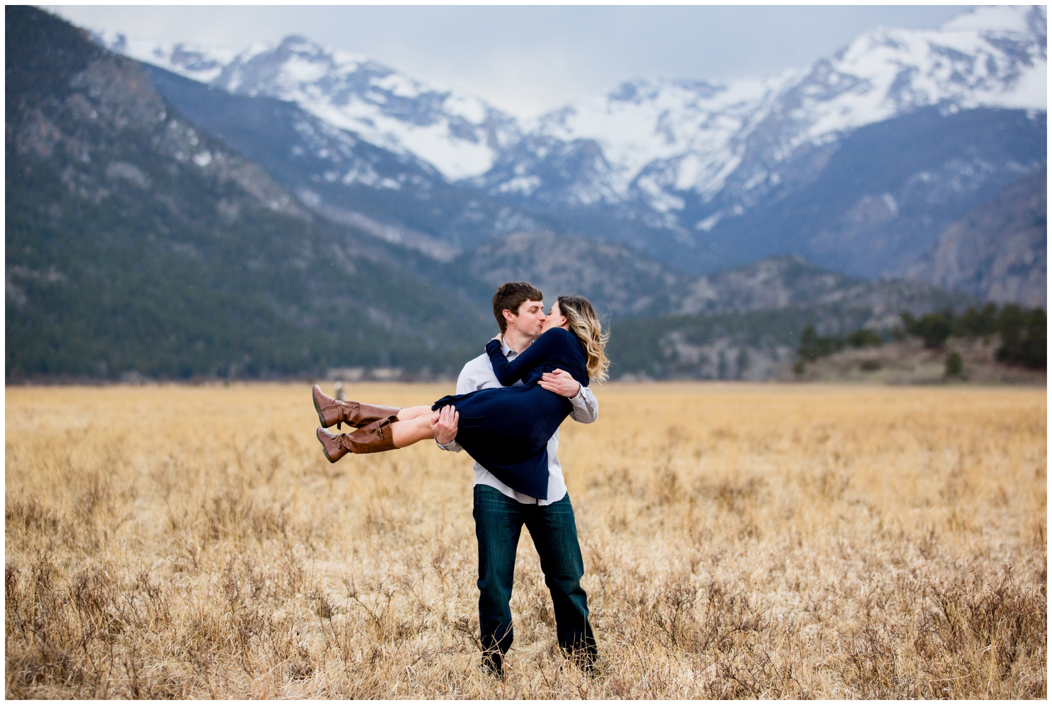 guy lifting fiancé during their estes park engagement photography session