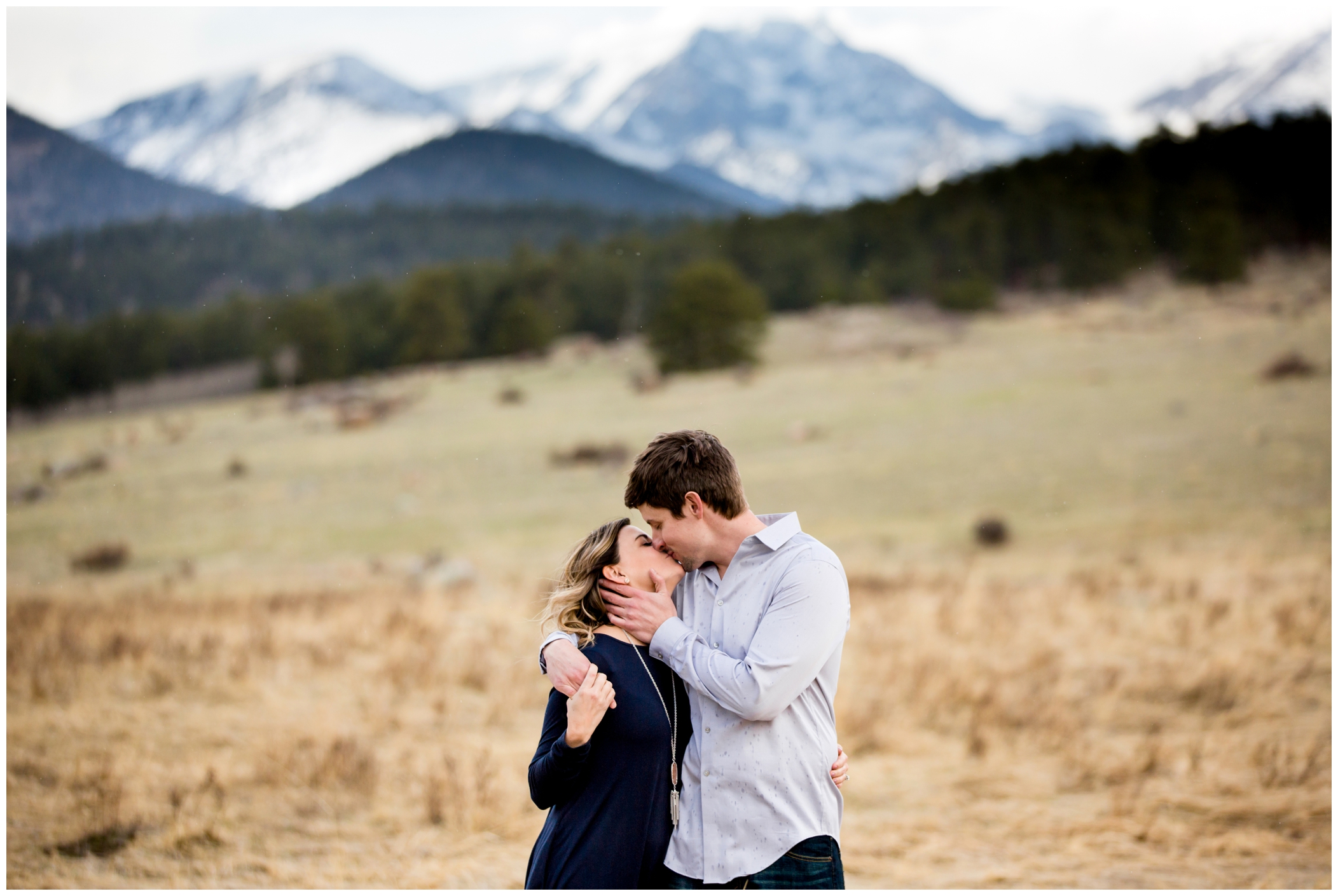 couple kissing in the mountains at their Estes Park engagement portraits 
