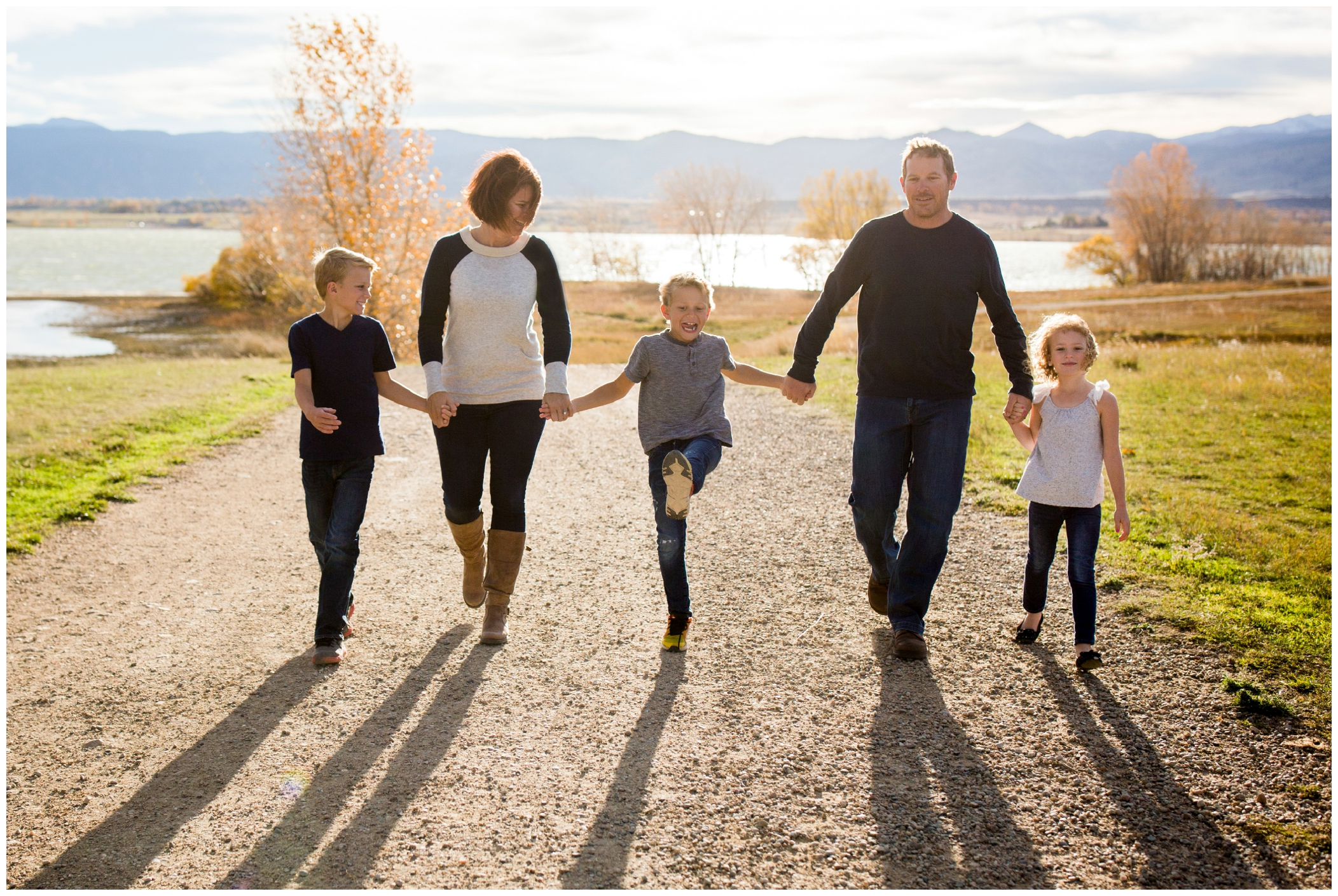 family walking with lake in background at Coot Lake Longmont family photography session 