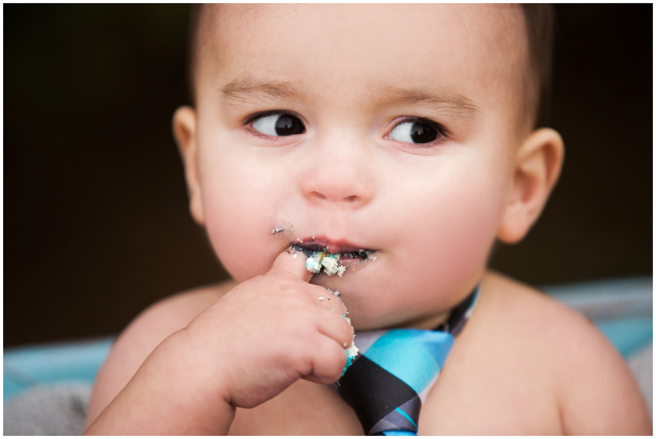 one year old boy eating cake at outdoor cake smash photos in Ft. Collins CO