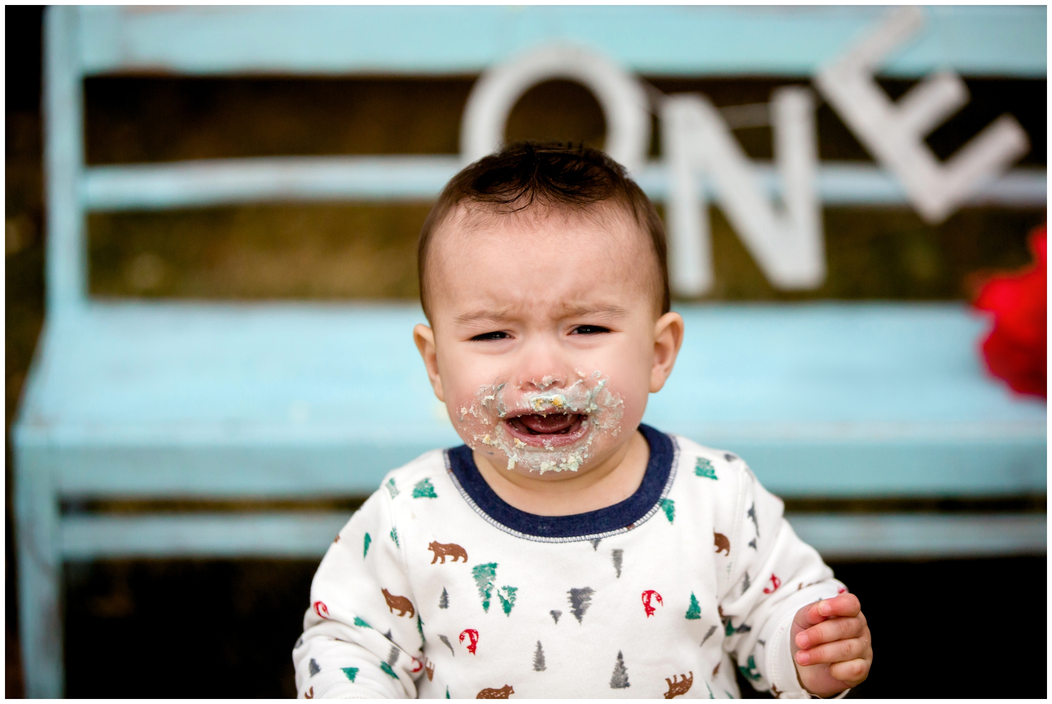 baby crying during his outdoor first birthday cake smash photo session