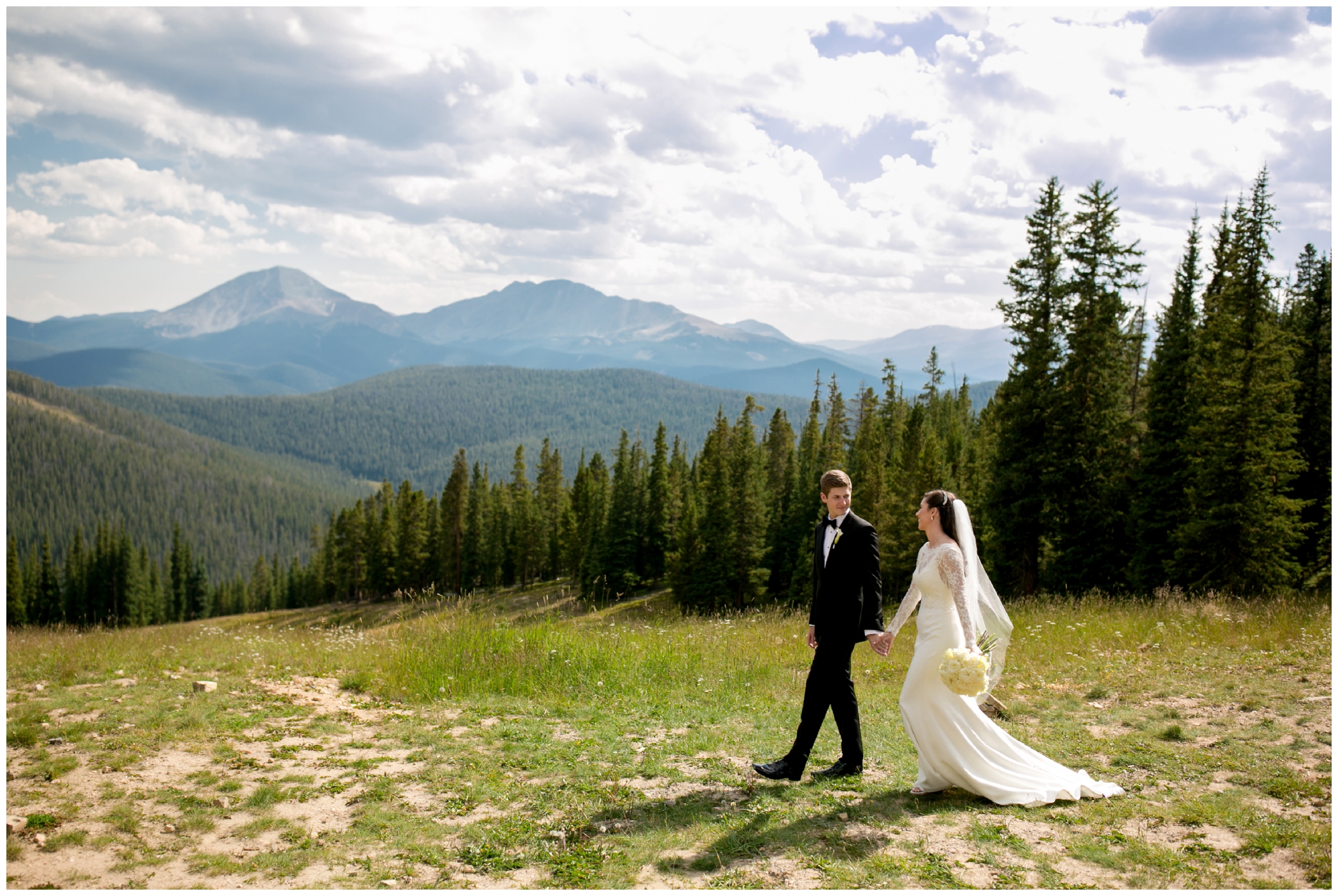 bride and groom walking in the mountains during Keystone Colorado wedding portraits 