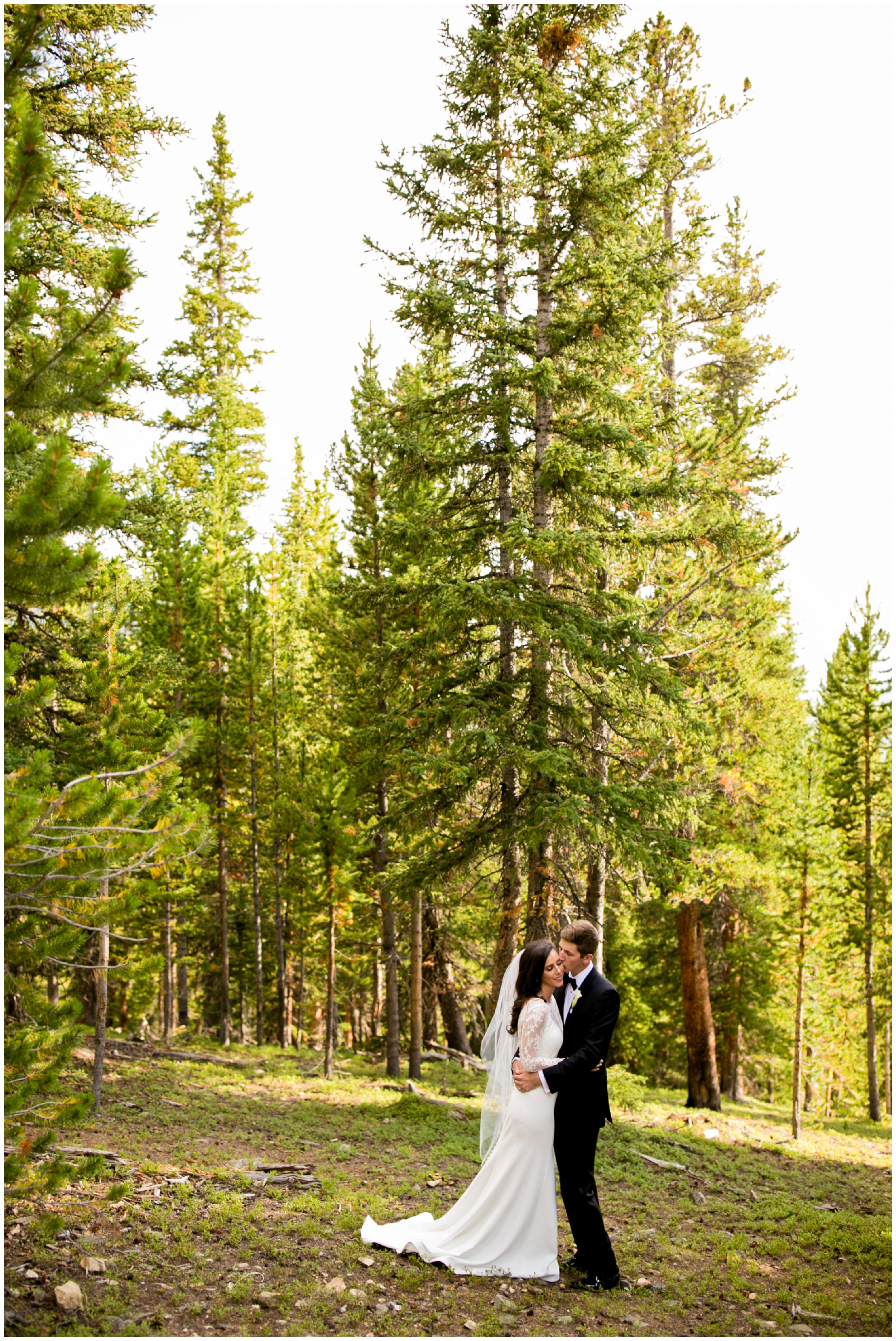 bride and groom posing in the forest at Timber Ridge Keystone Colorado wedding 