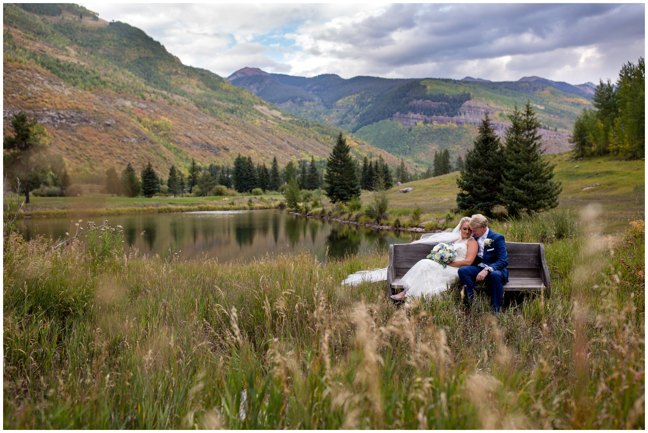 bride and groom on bench during Vail Colorado wedding photos 