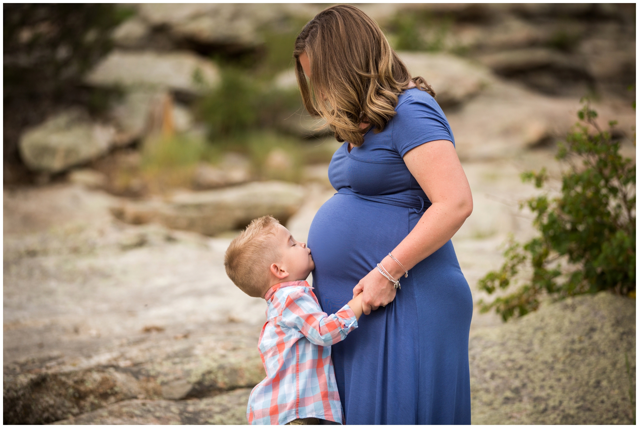 boy kissing mom's belly at Colorado maternity family photography session 