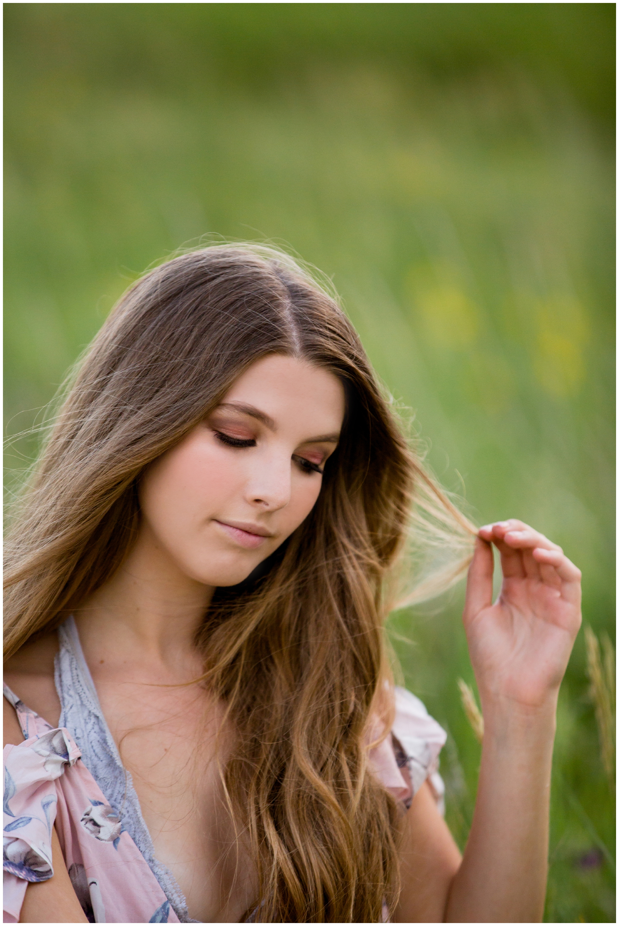girl sitting in field at Westminster Colorado senior photography session 