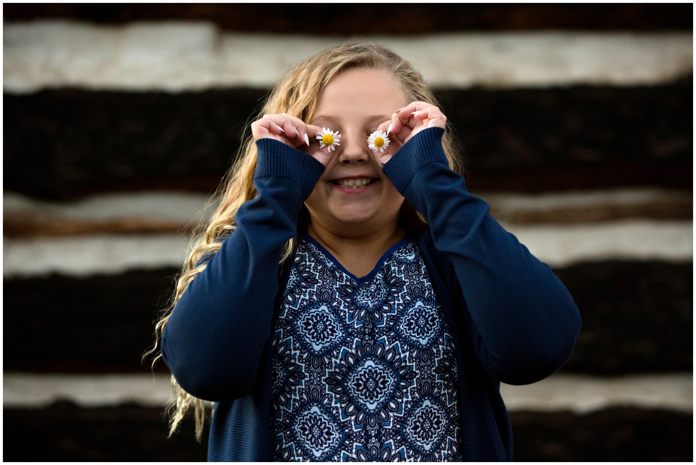 girl with flower over eyes at Colorado family photography session 