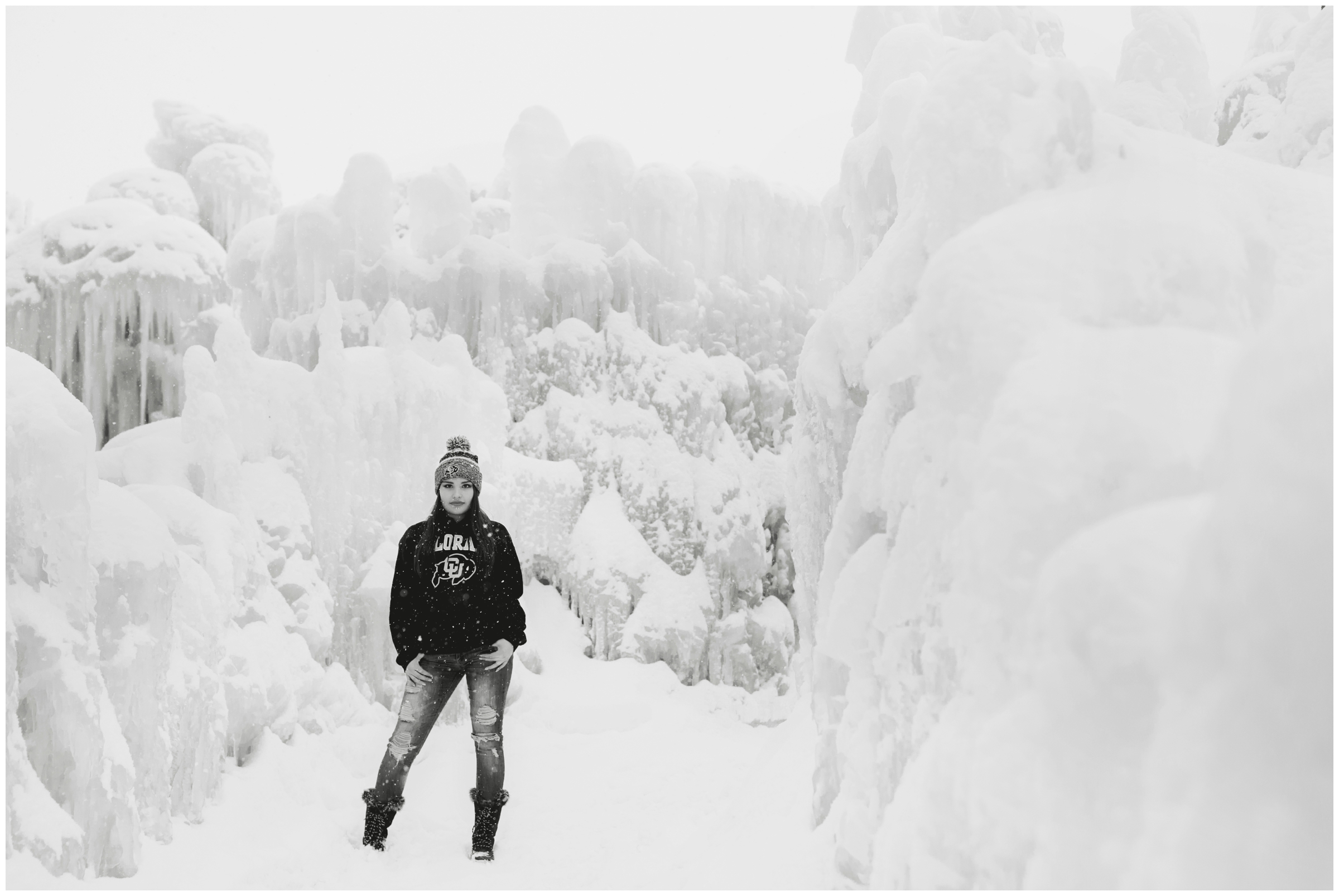 teen girl standing in the snow with the Colorado ice castles in background