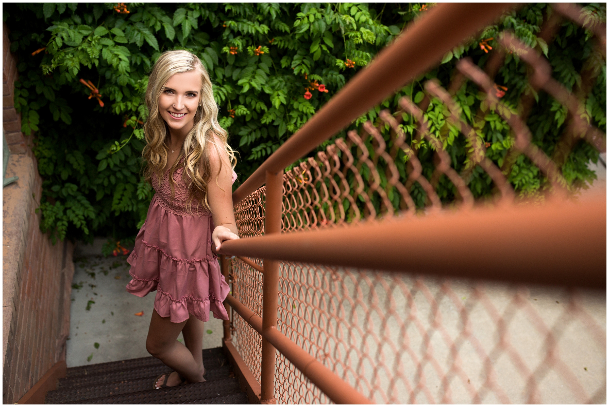 teen girl on metal staircase at Longmont senior portraits at Callahan House 