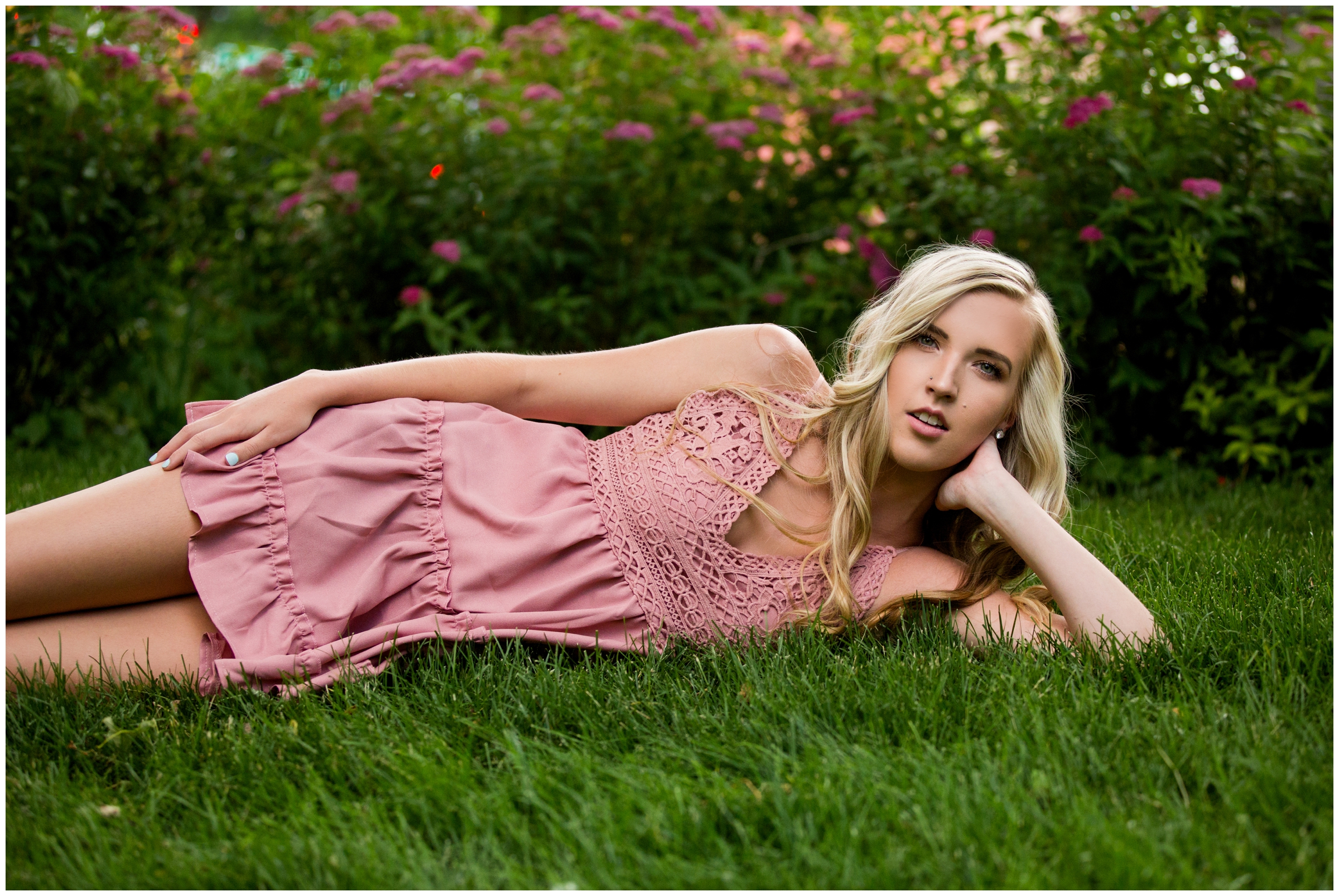 girl laying in grass at garden senior pictures in Longmont Colorado 