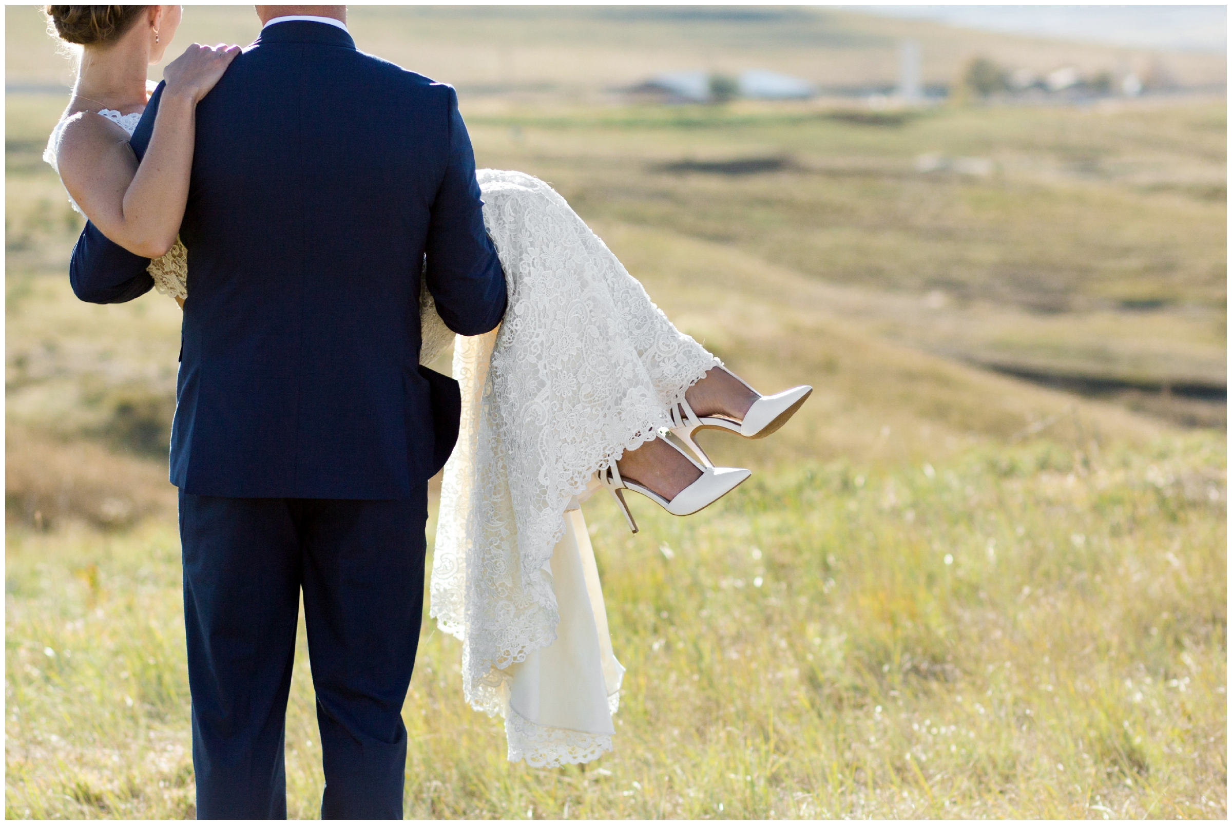 groom holding bride with mountains in background at Boulder County Colorado wedding