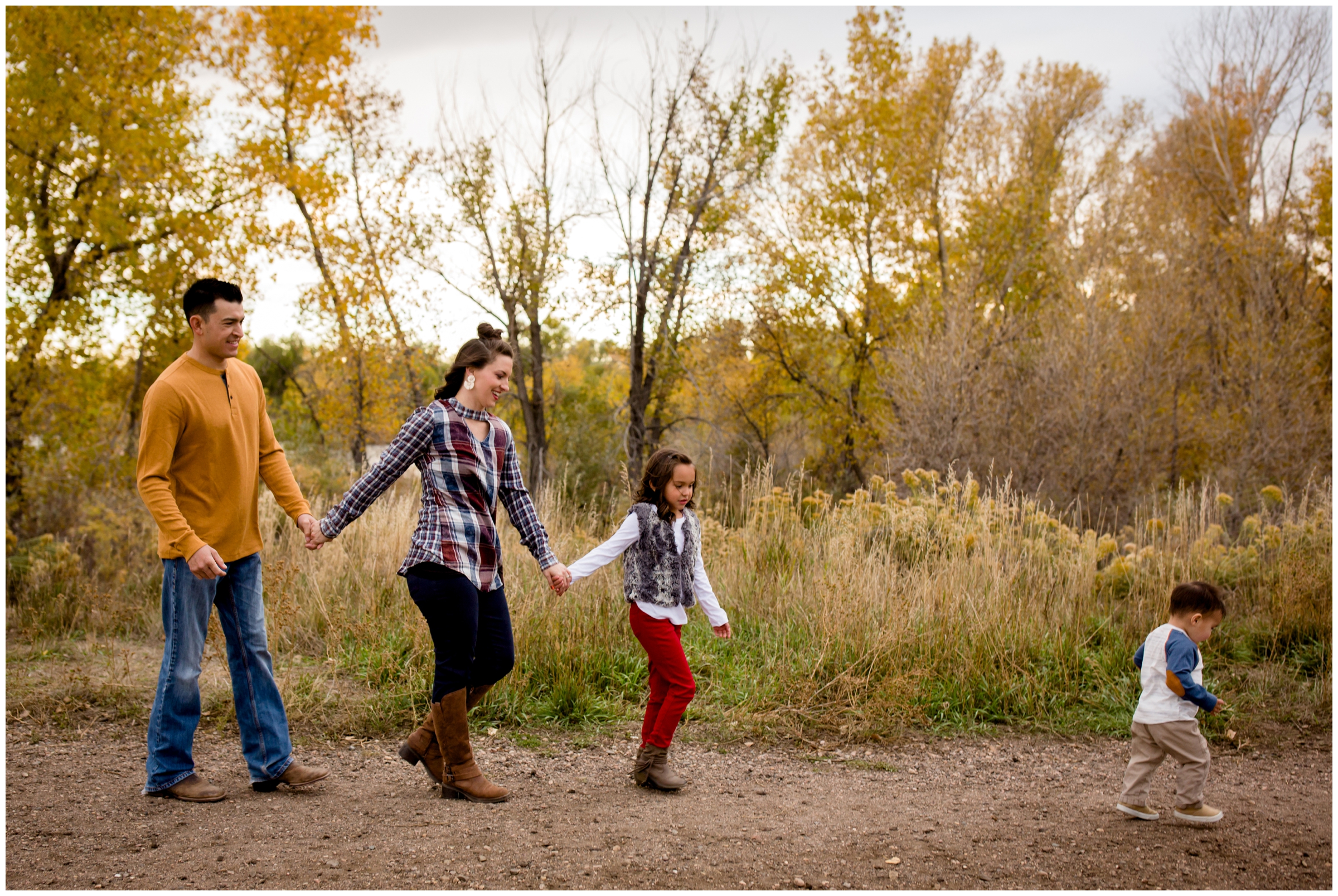 family walking and holding hands during Fort Collins portrait session at Riverbend Ponds