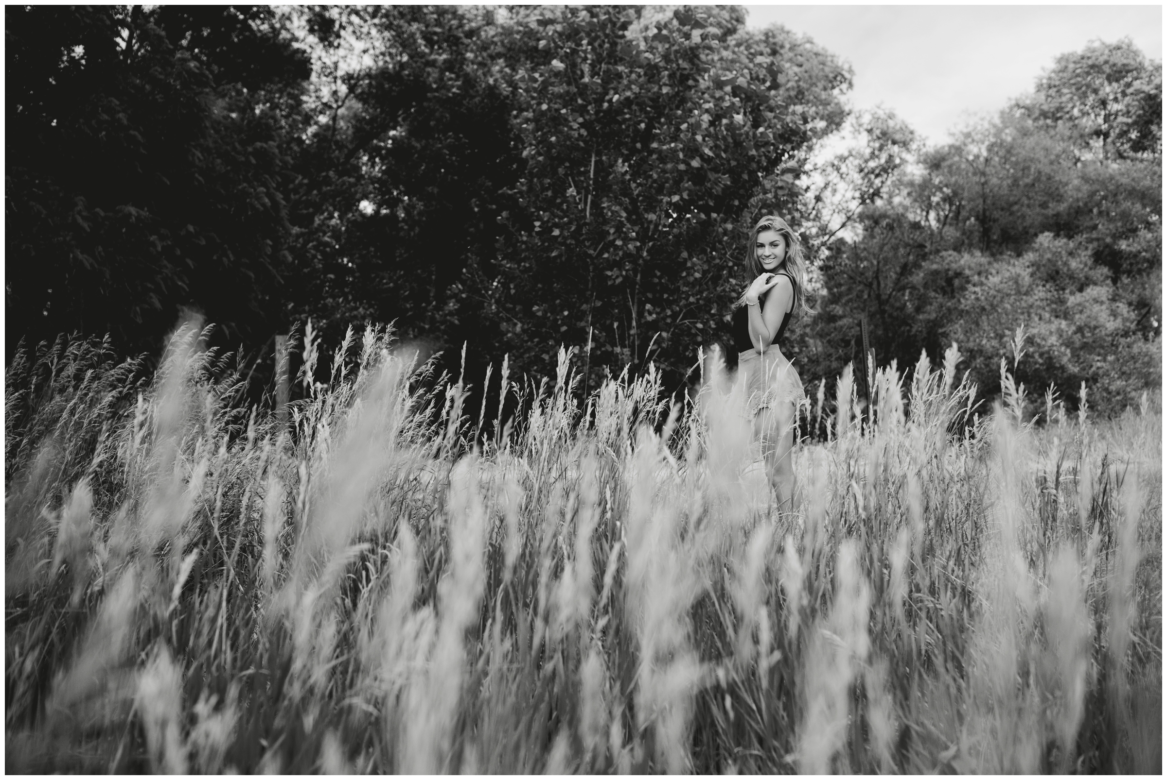 girl standing in long grasses at Colorado senior photography session in Longmont CO