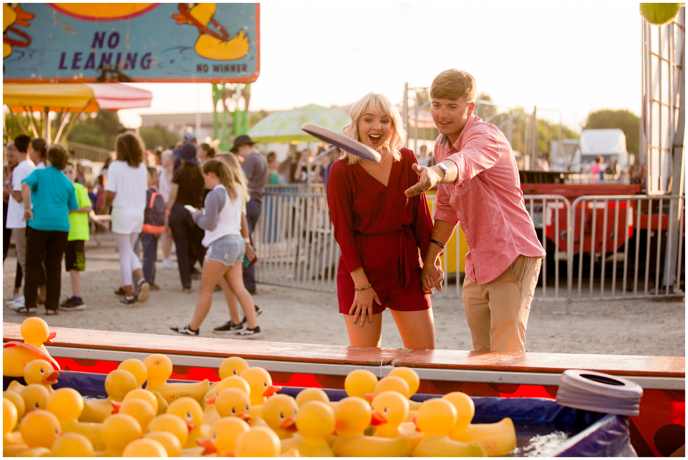 couple playing games at fair engagement pictures in Longmont Colorado 