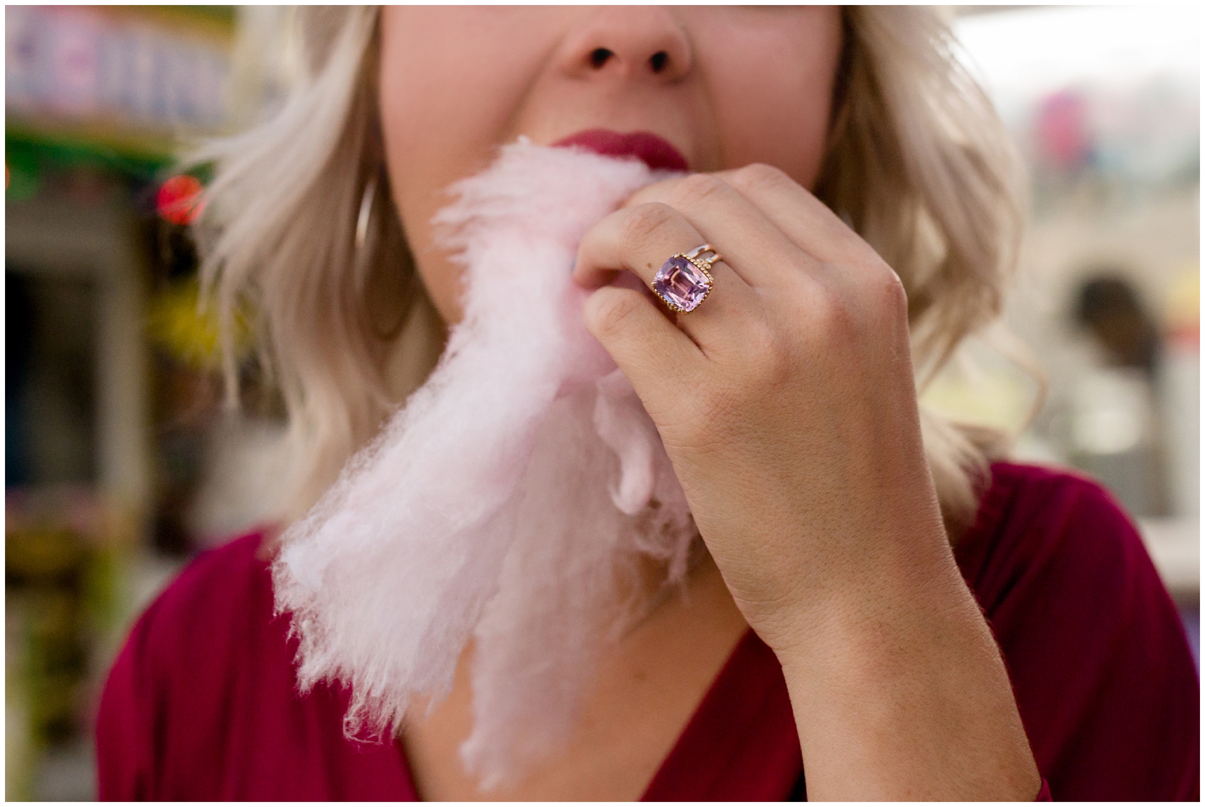 woman eating cotton candy at Colorado carnival engagement pictures 