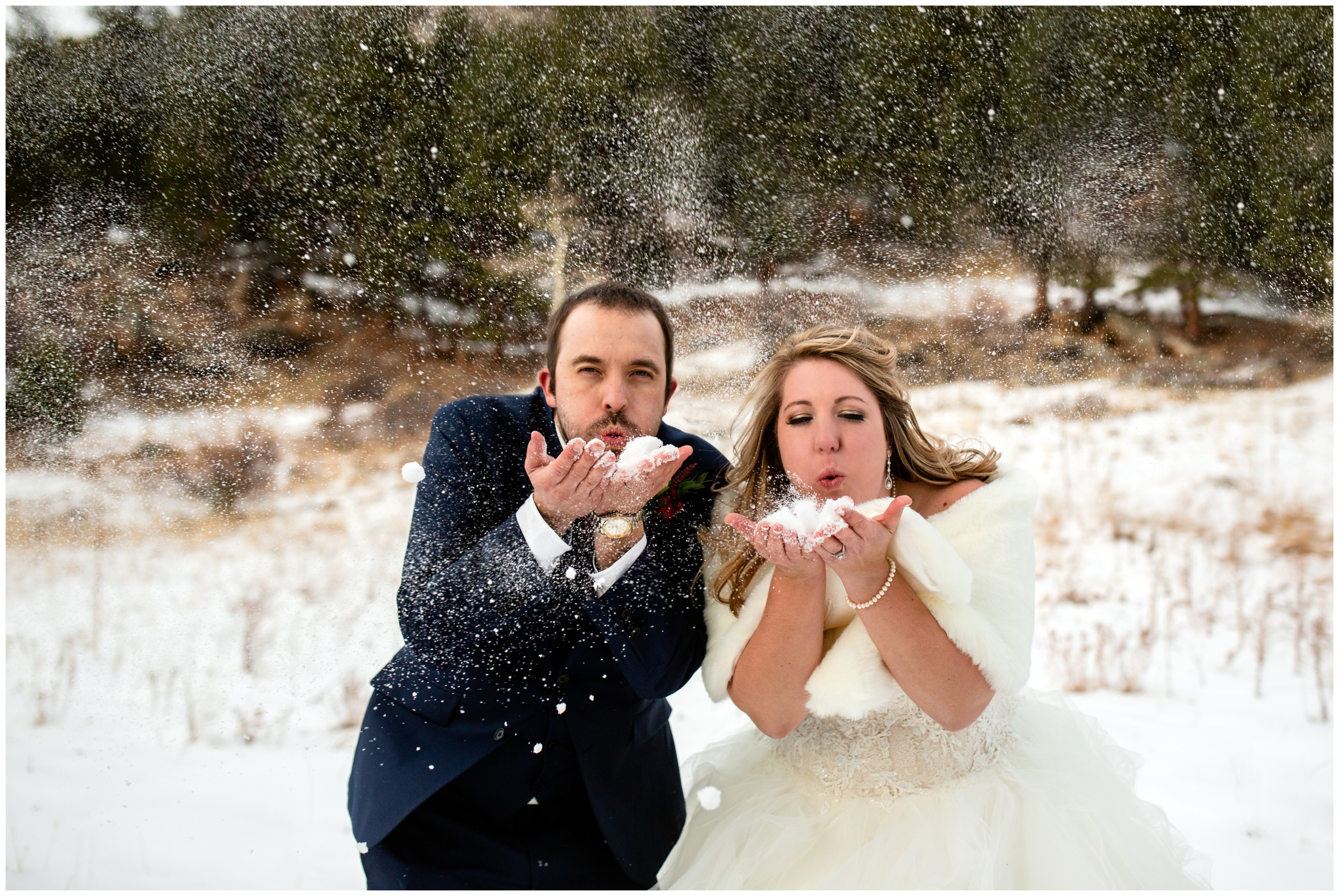 bride and groom blowing snow at Estes Park Colorado winter wedding 