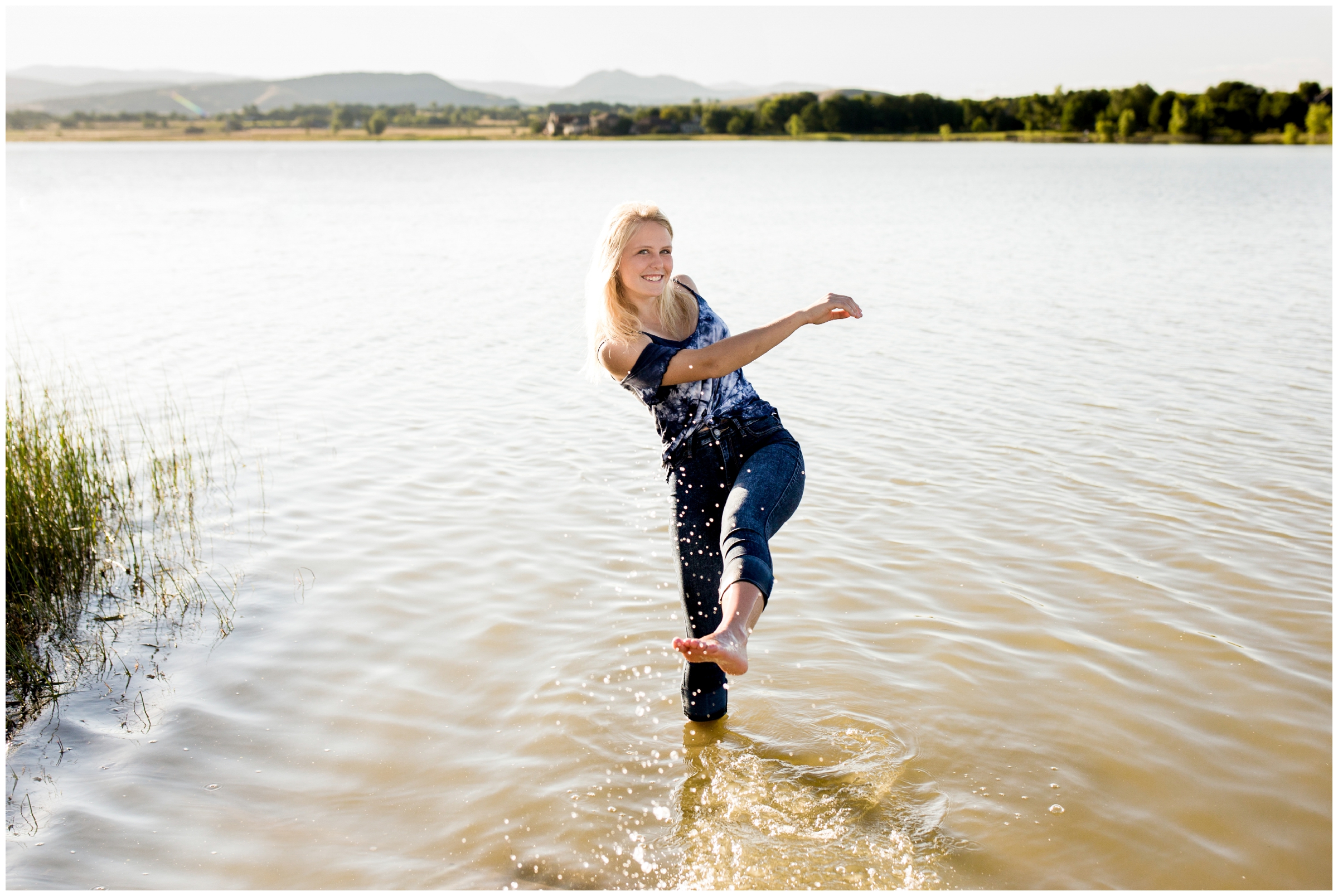 girl kicking water in McIntosh Lake during senior portraits by best Longmont Colorado senior photographer Plum Pretty Photography 