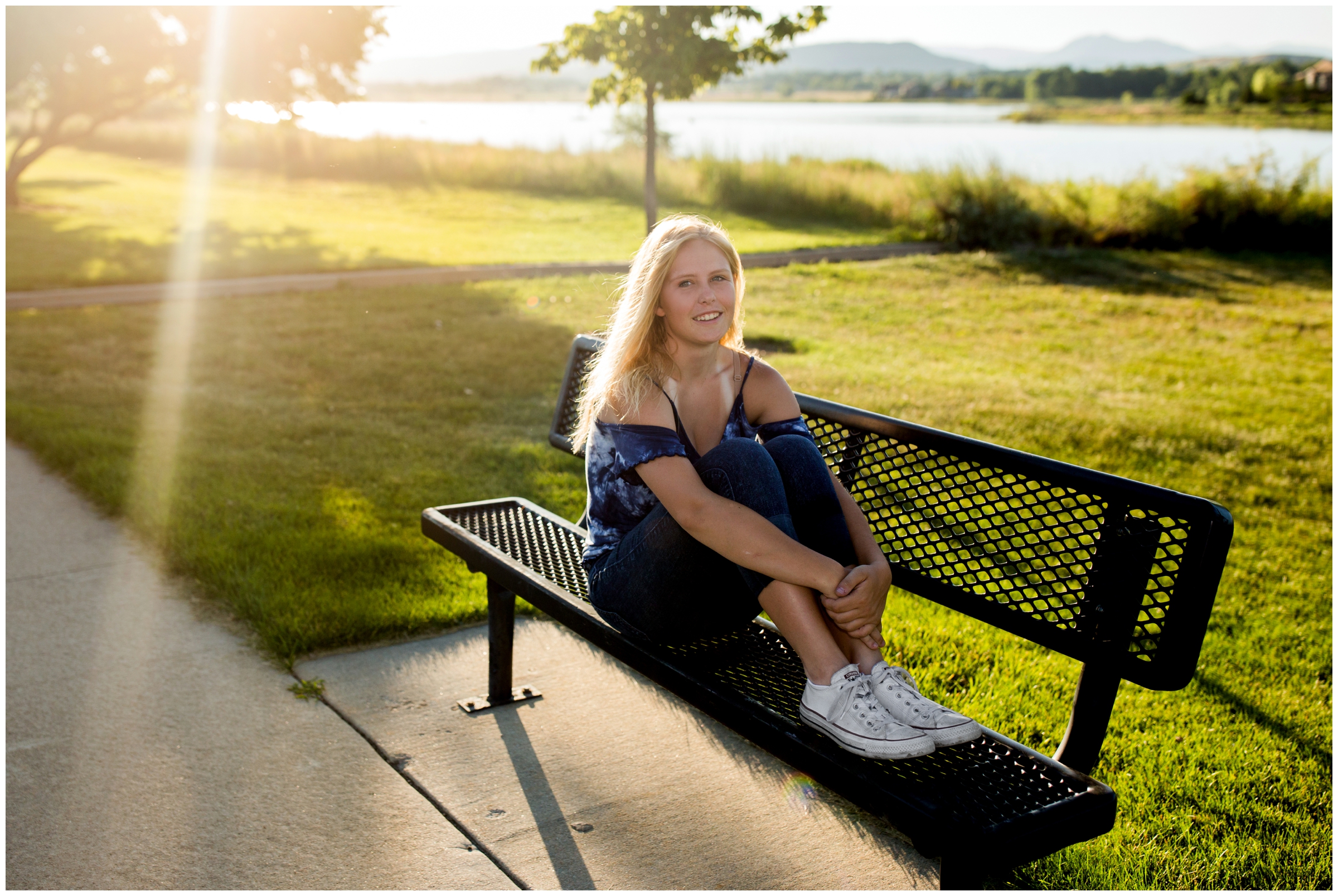 girl sitting on bench with Longmont mountain lake in background